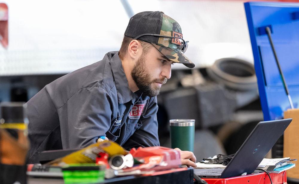 A Pete Store Diesel service Technician performing a diagnostic check on a Peterbilt